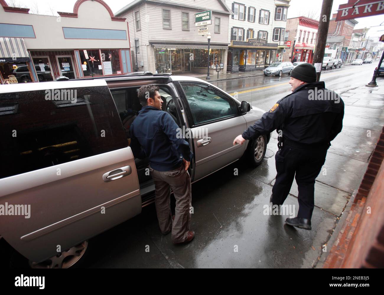 In this Jan. 19, 2010 photo, Emilio Maya, left, speaks to a local police  officer outside his business, the Tango Cafe, in Saugerties, N.Y. There was  a time, when Emilio and Analia