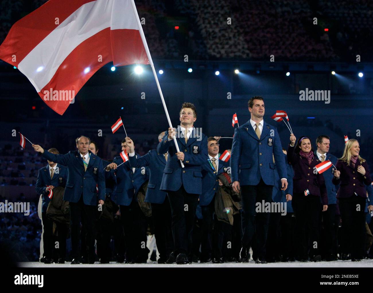 Austrian athletes, led by flagbearer Andreas Linger, march in during