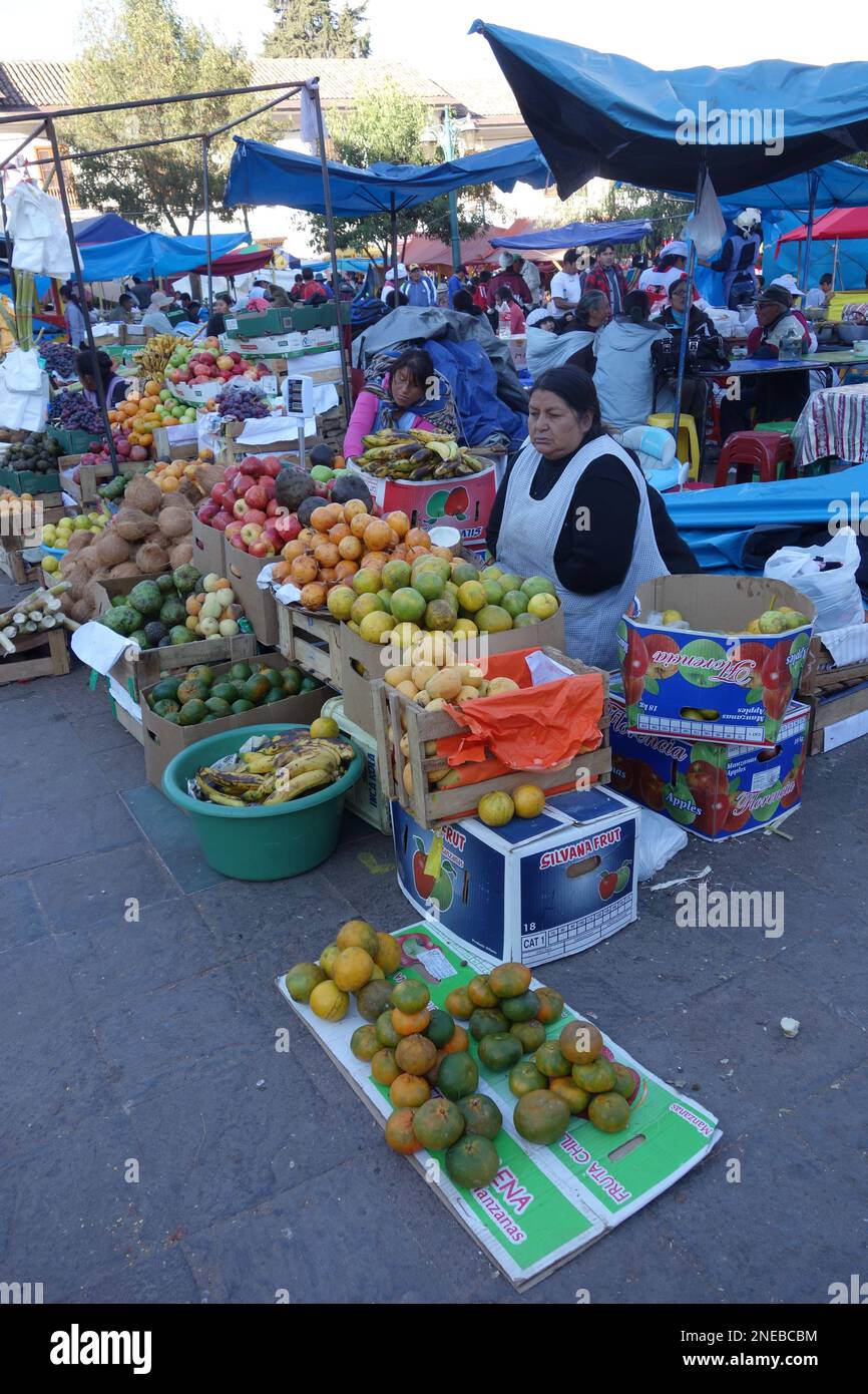 Women wearing traditional clothes selling food and vegetables at a