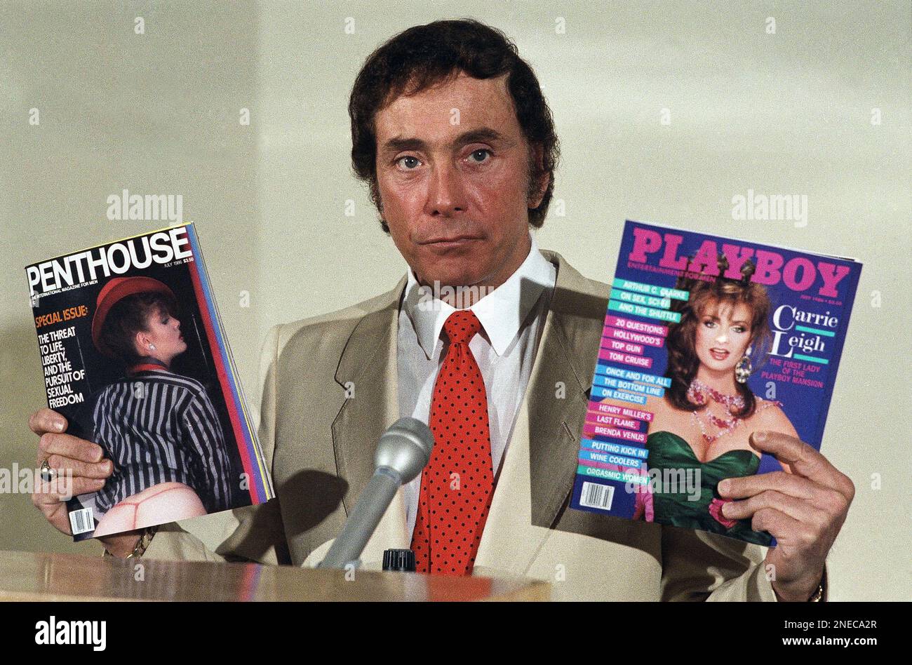 Bob Guccione, publisher of Penthouse magazine, holds up copies of Penthouse and Playboy magazines during a news conference in New York, June 5, 1986 photo