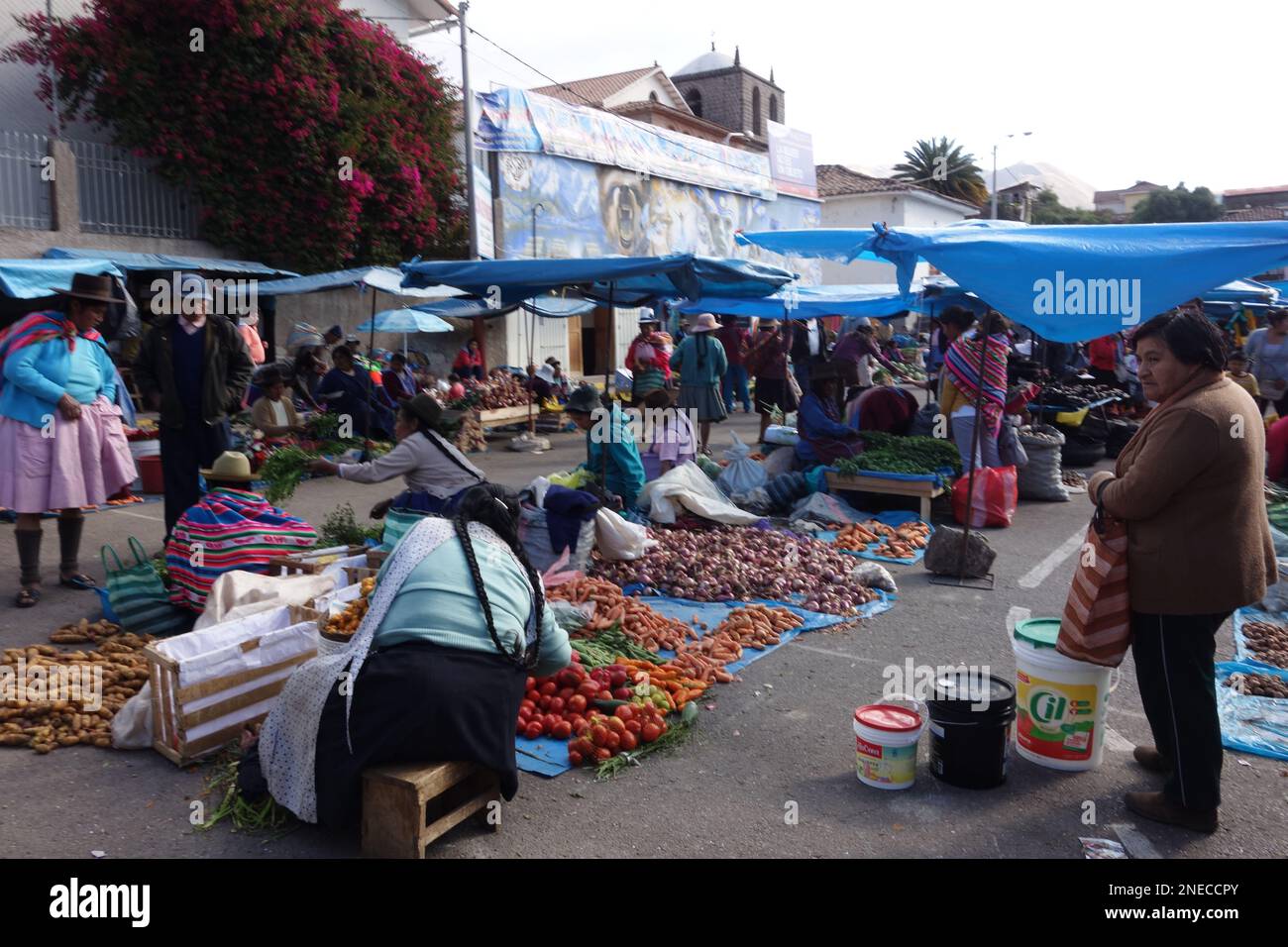 Women wearing traditional clothes selling food and vegetables at a
