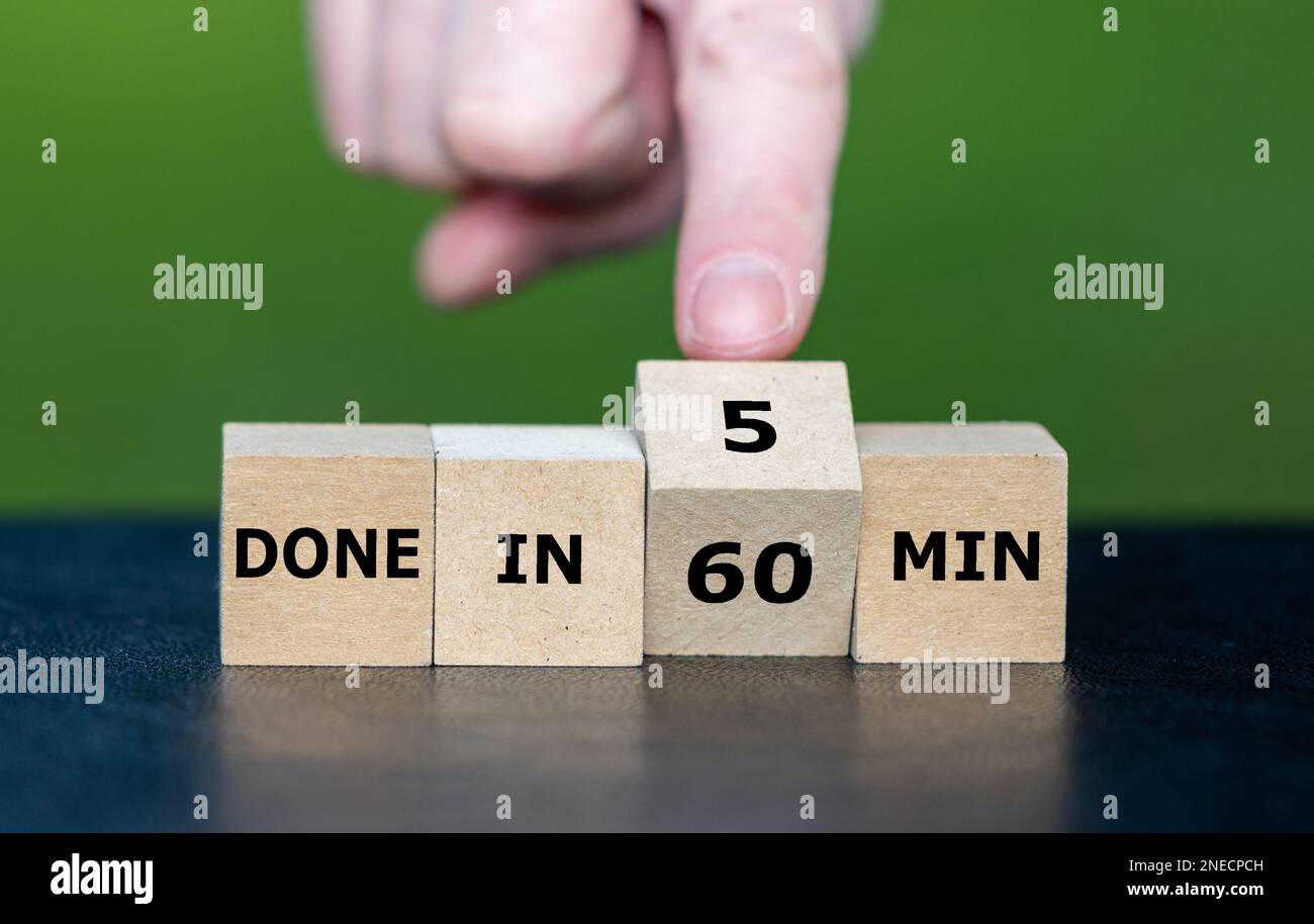 Hand turns wooden cubes and changes the expression 'done in 60 min' to 'done in 5 min'. Stock Photo