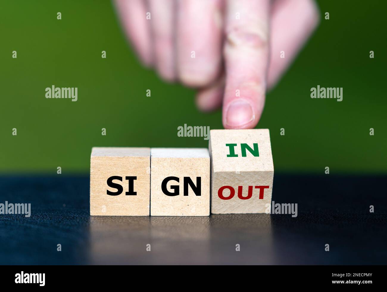 Hand turns dice and changes the expression 'sign out' to 'sign in'. Stock Photo