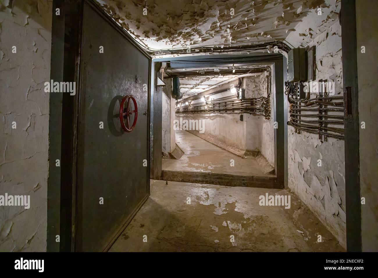 Hermetic rusty door of the bunker in underground abandoned tunnel