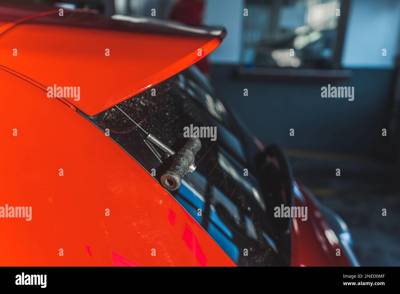Shot of a car spoiler being cut with a cutting cord. Rear windshield. . High quality photo Stock Photo