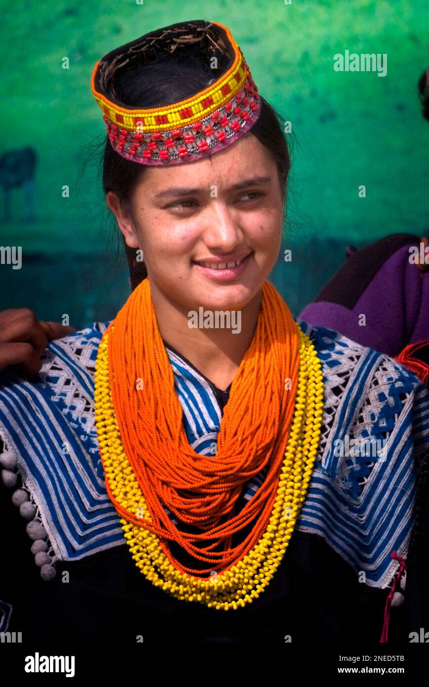 A Pakistani girl from Kalash tribe in traditional costume performs a ...