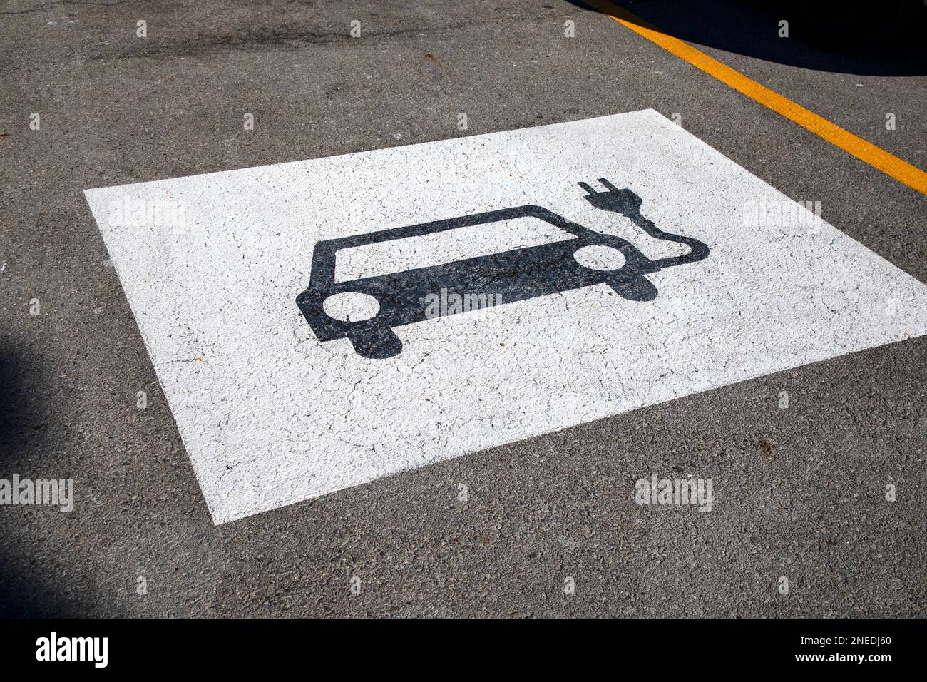 Electric Vehicle parking spot sign on pavement. Stock Photo