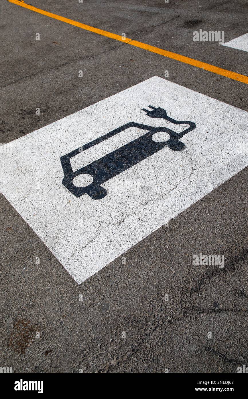 Electric Vehicle parking spot sign on pavement. Stock Photo