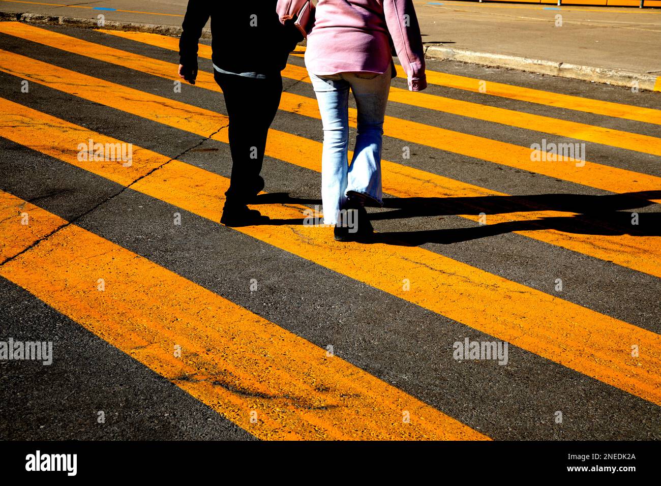 Yellow painted crosswalk road line markings Stock Photo Alamy