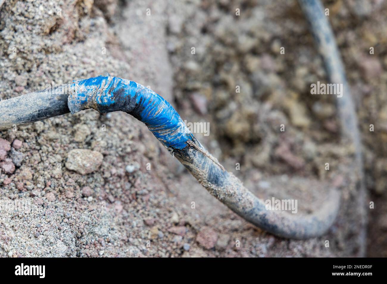 Improper repair of cable after excavator damage Stock Photo