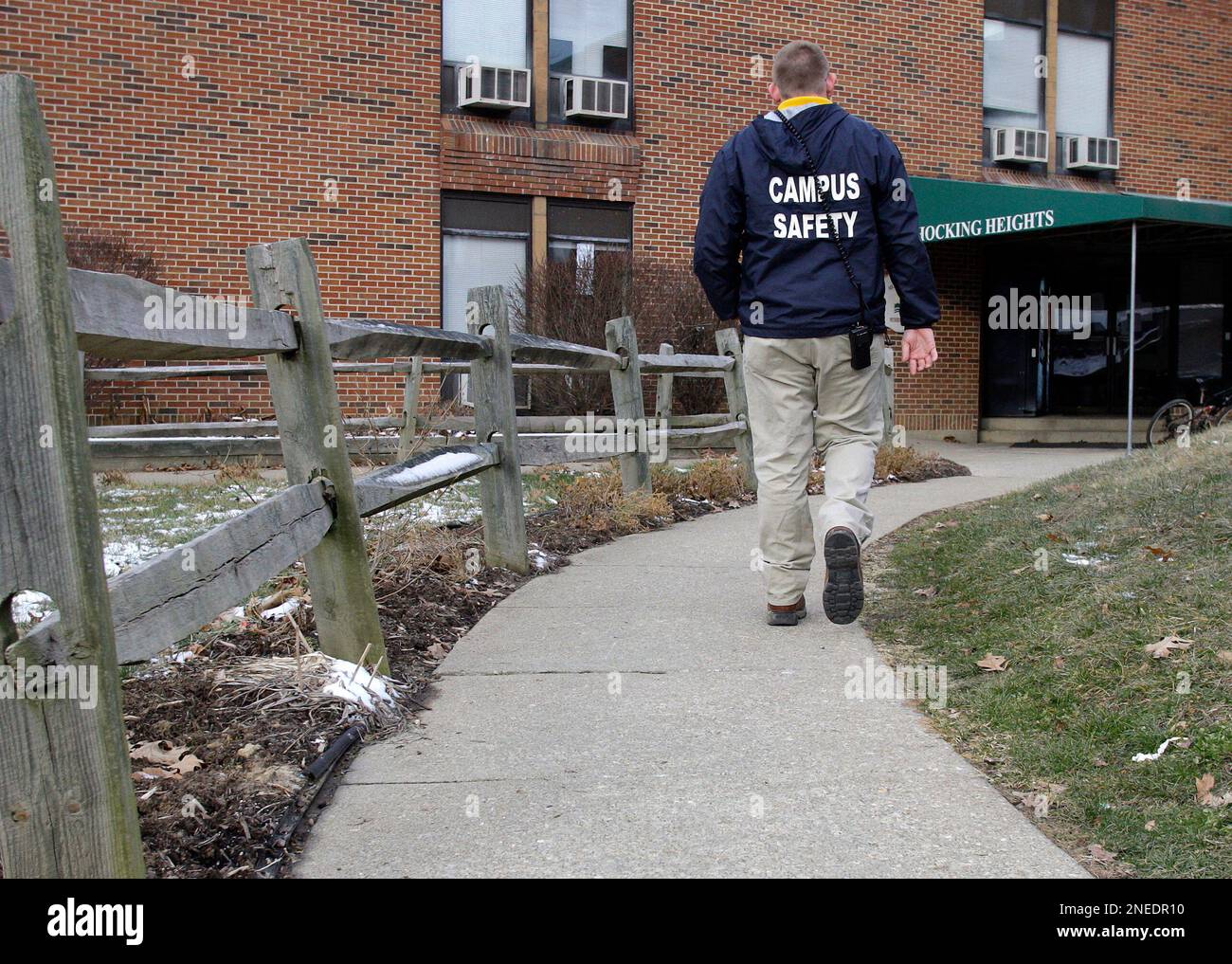 A campus safety officer patrols outside of Hocking Heights residence
