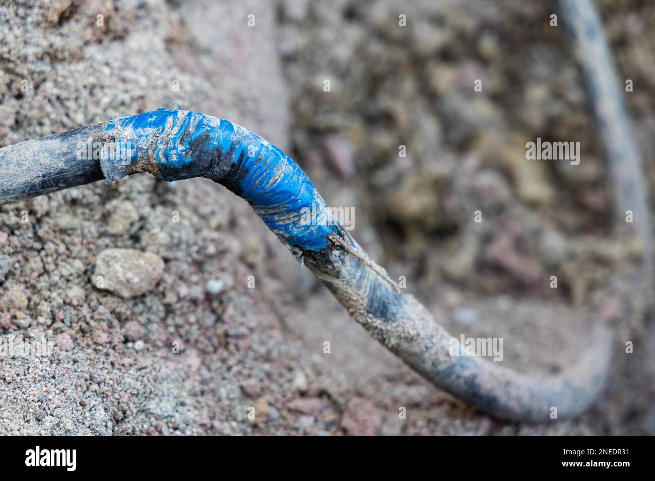 Improper repair of cable after excavator damage Stock Photo