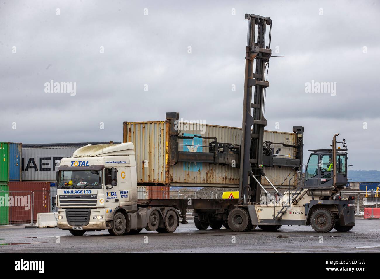 Container handler removes a shipping container from a lorry at the Port of Belfast. Any deal on the Northern Ireland Protocol that does not repair the 'constitutional damage' it has caused will fail to convince the DUP to return to powersharing, a senior party figure has warned. MP Sammy Wilson said the fundamental issue that needed confronting was the 'democratic deficit' created by Northern Ireland being subject to EU rules over which local politicians had no influence on. Stock Photo