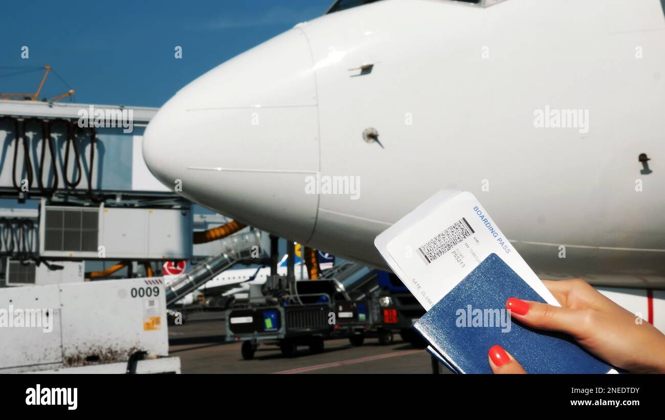 Closeup, female hands holding Airline boarding pass tickets, Boarding