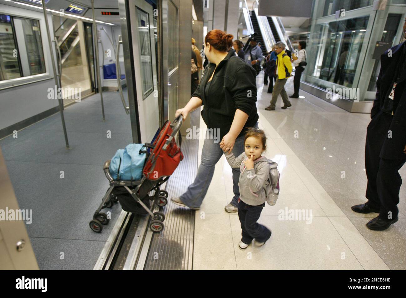 Passengers board the new airport train system AeroTrain at B gate