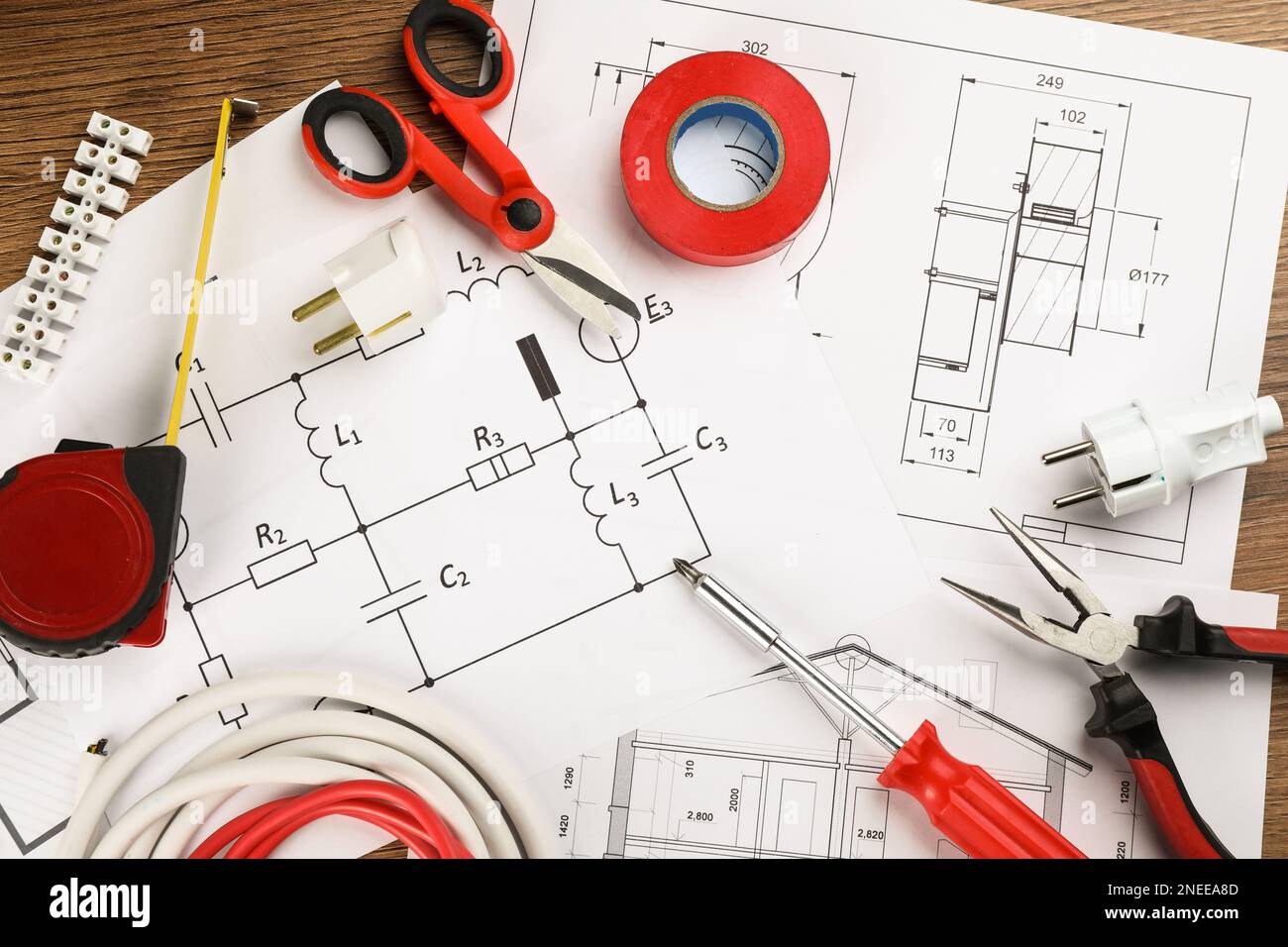 Flat lay composition with electrician's tools and house plan sheets on