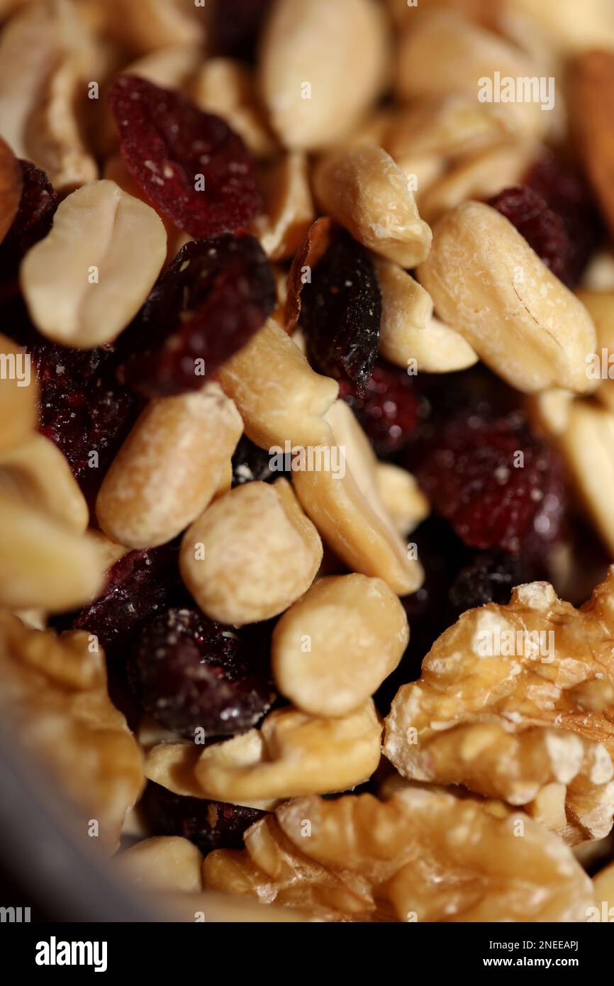 Mix of dried cranberries fruits almonds and nuts in a bowl close up modern background high quality big size stock photos print Stock Photo