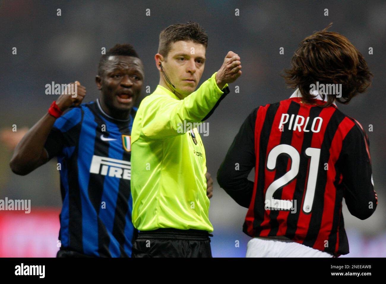 Referee Rocchi, center, gestures with AC Milan midfielder Andrea Pirlo ...