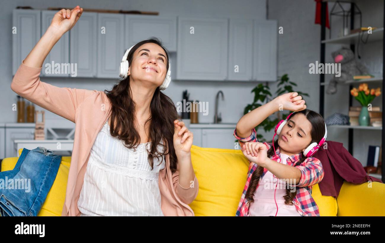 mother daughter dancing listening music. Beautiful photo Stock Photo