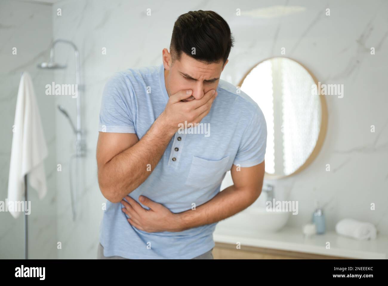 Man suffering from nausea in bathroom. Food poisoning Stock Photo Alamy