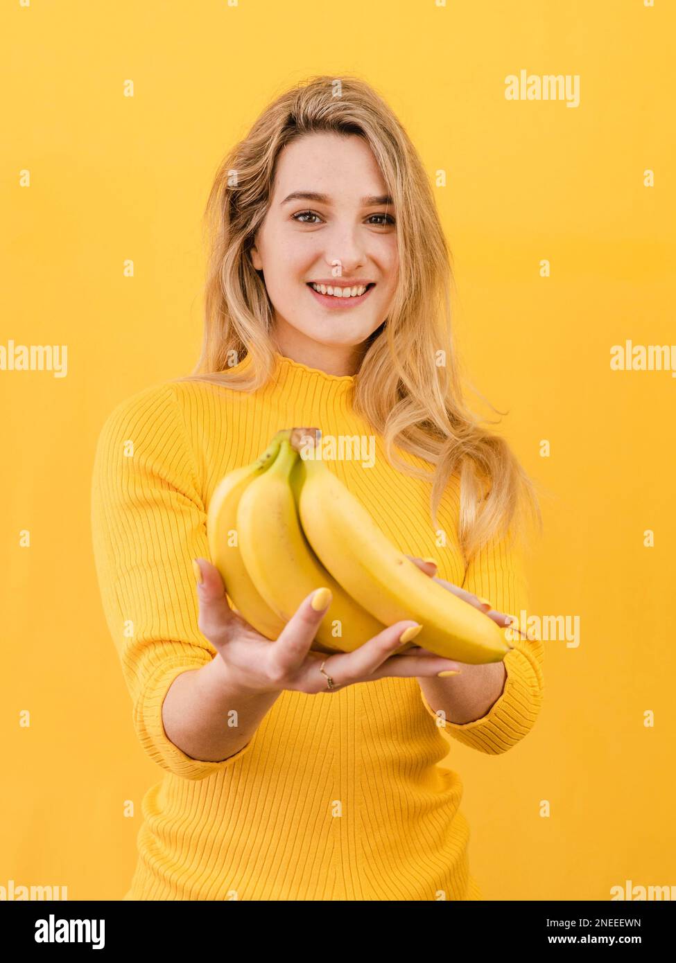 front view woman holding bananas Stock Photo