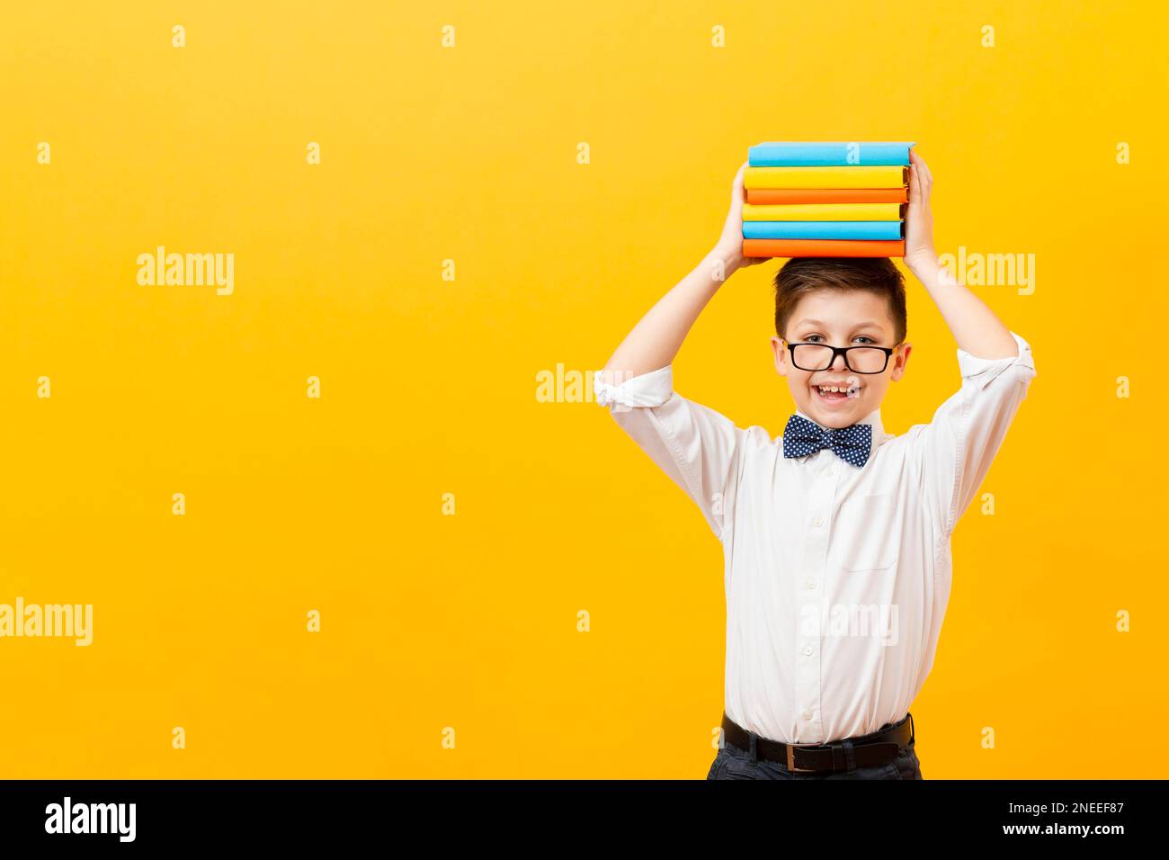 copy space boy holding stack books Stock Photo