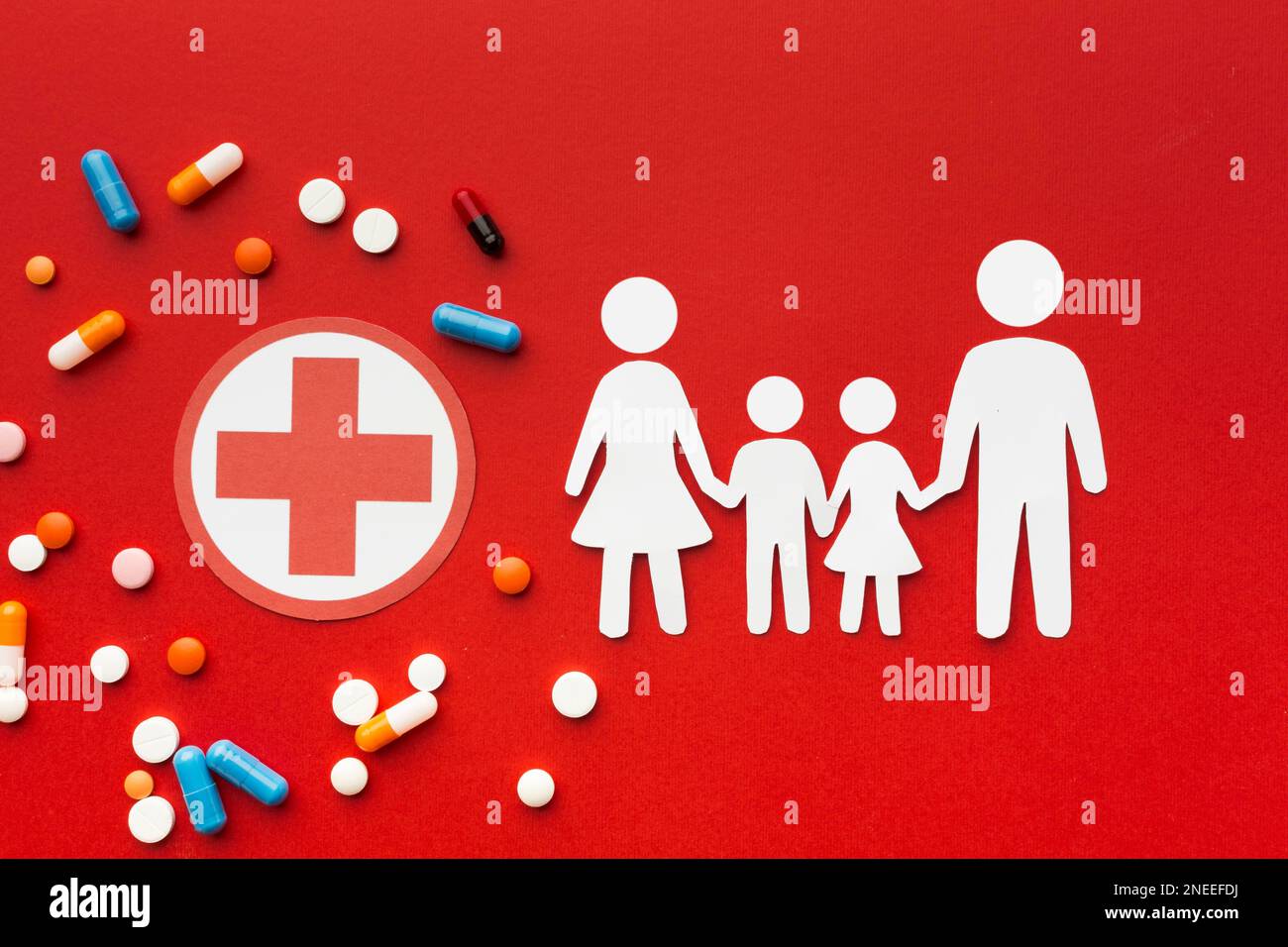 Cardboard family shapes with drugs red cross symbol Stock Photo