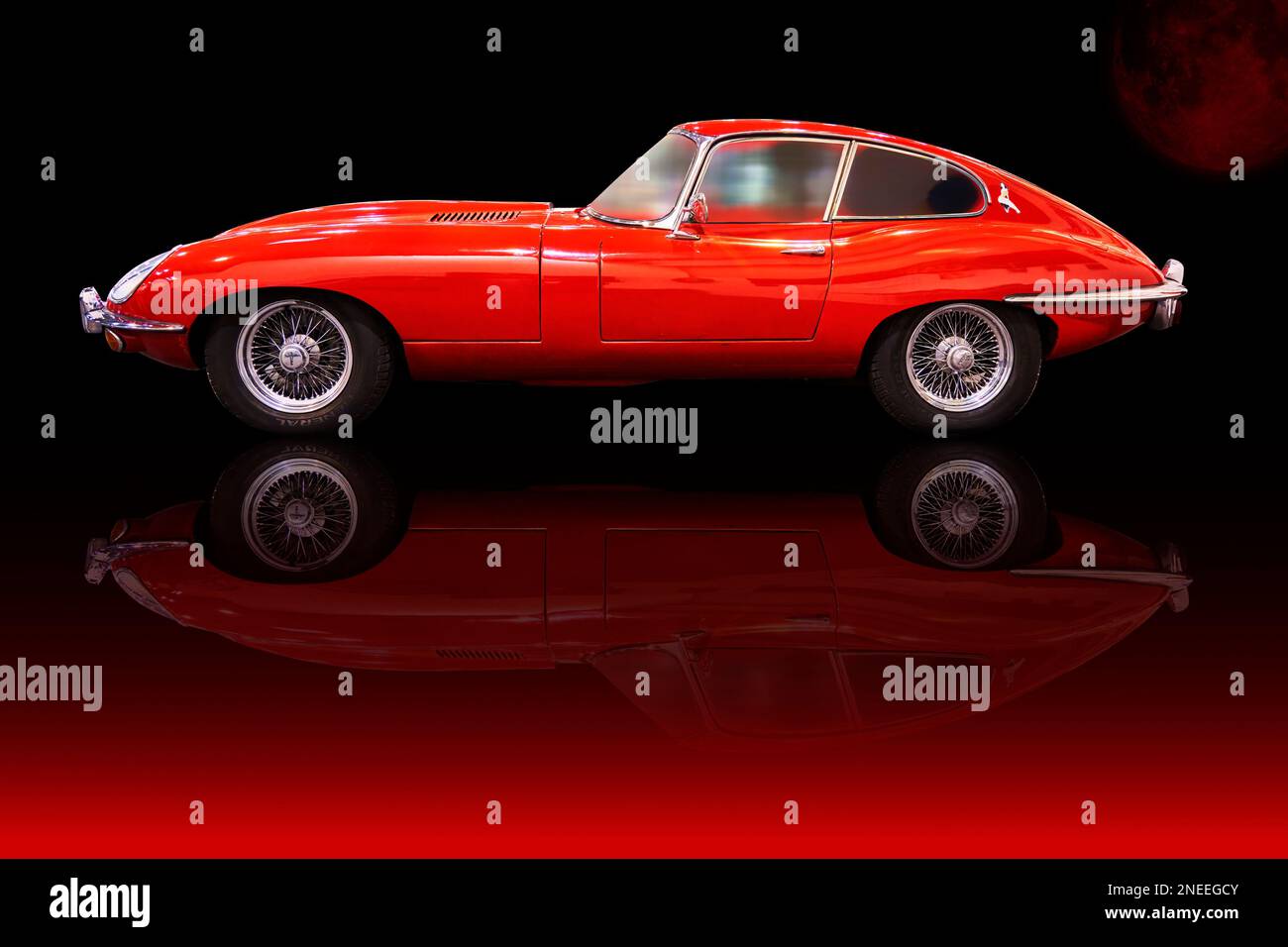 Jaguar E Type in side view, red painted classic sports car from England