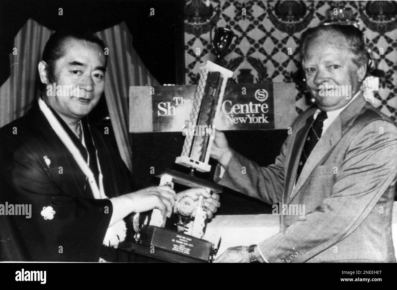 Dr. Yoshiro Nakamatsu, left, receives the Grand Prix at the annual