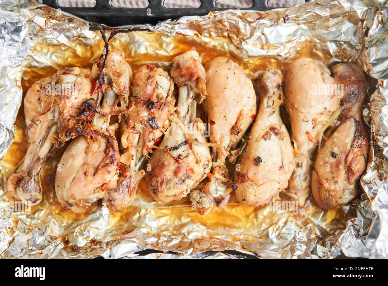 Baked chicken drumsticks without skin. Baked in foil with onions and seasonings. Home cooking