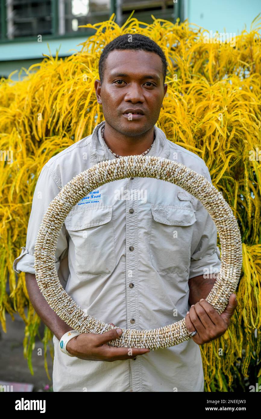 Native of the Tolai tribe with a hoop Shell money made from the shells of the Nassa snail (Nassarius arcularius), Kokopo, East New Britain, Bismarck Stock Photo
