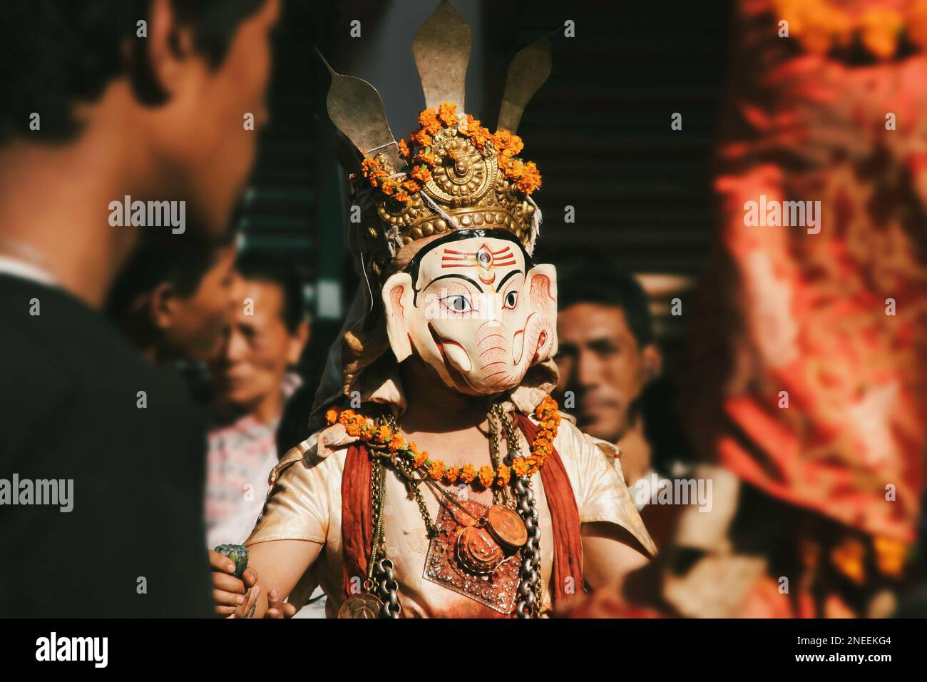 A Person wearing a decorative elephant Ganesh mask, Traditional cultural Nepalese costume at religious street festival celebration in Kathmandu, Nepal Stock Photo