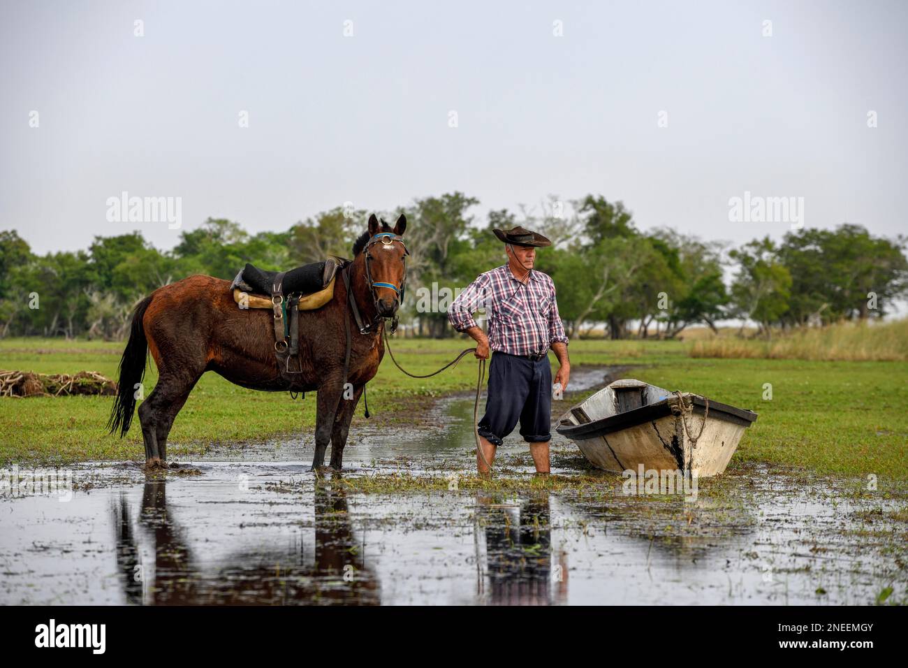 Gaucho with horse and boat at Puesto Mingo, Esteros del Ibera, near Concepcion del Yaguarete Cora, Corrientes Province, Argentina Stock Photo