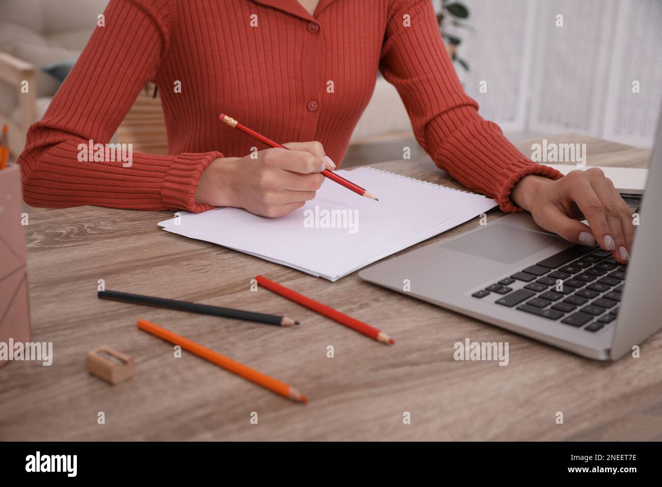 Woman drawing picture at online art lesson indoors, closeup. Distant ...