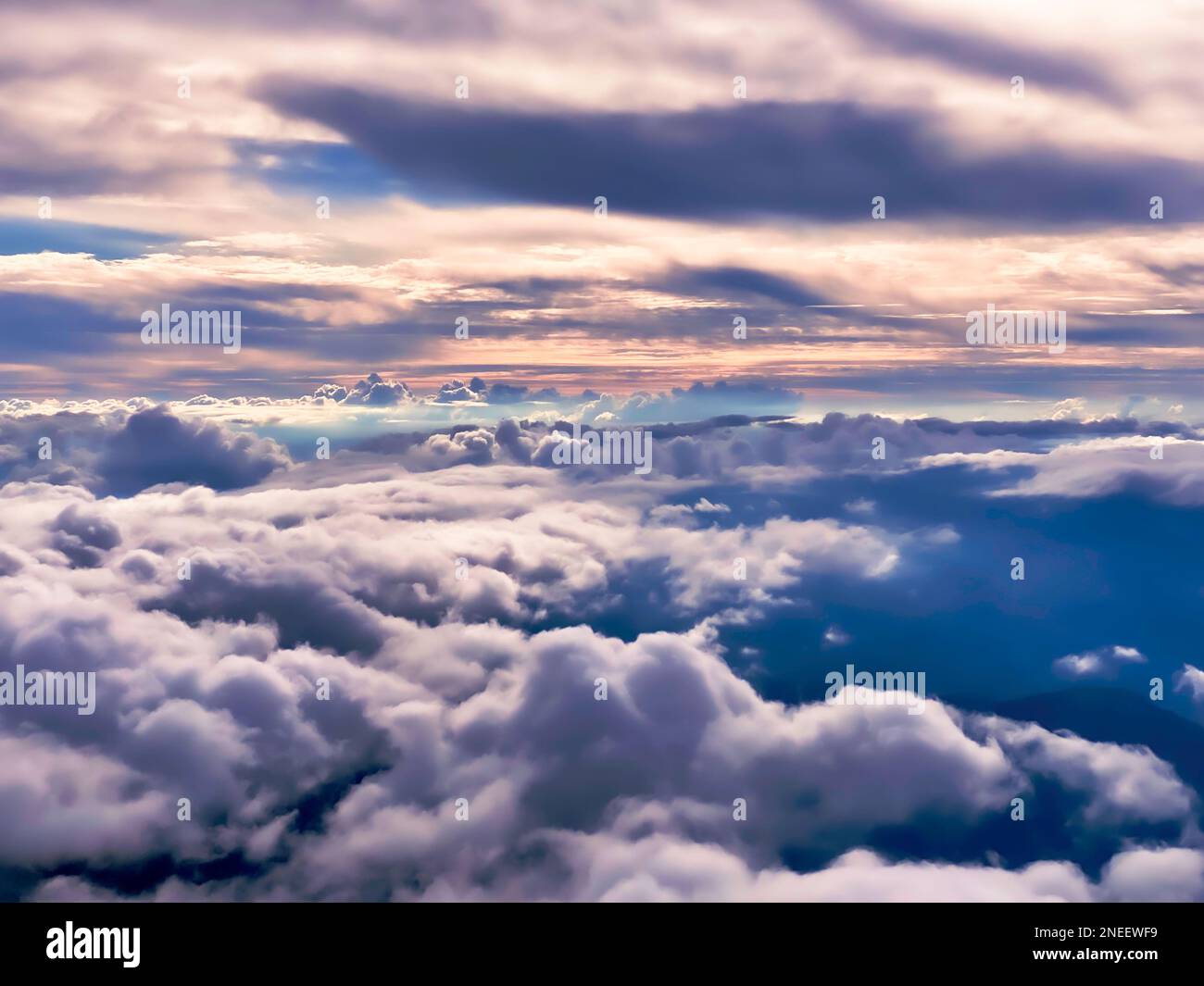 View from Above the Fluffy Nimbus Clouds and horizon at Sunset, high up aerial view. Mental Health, mindfulness, meditation, slow travel concept Stock Photo