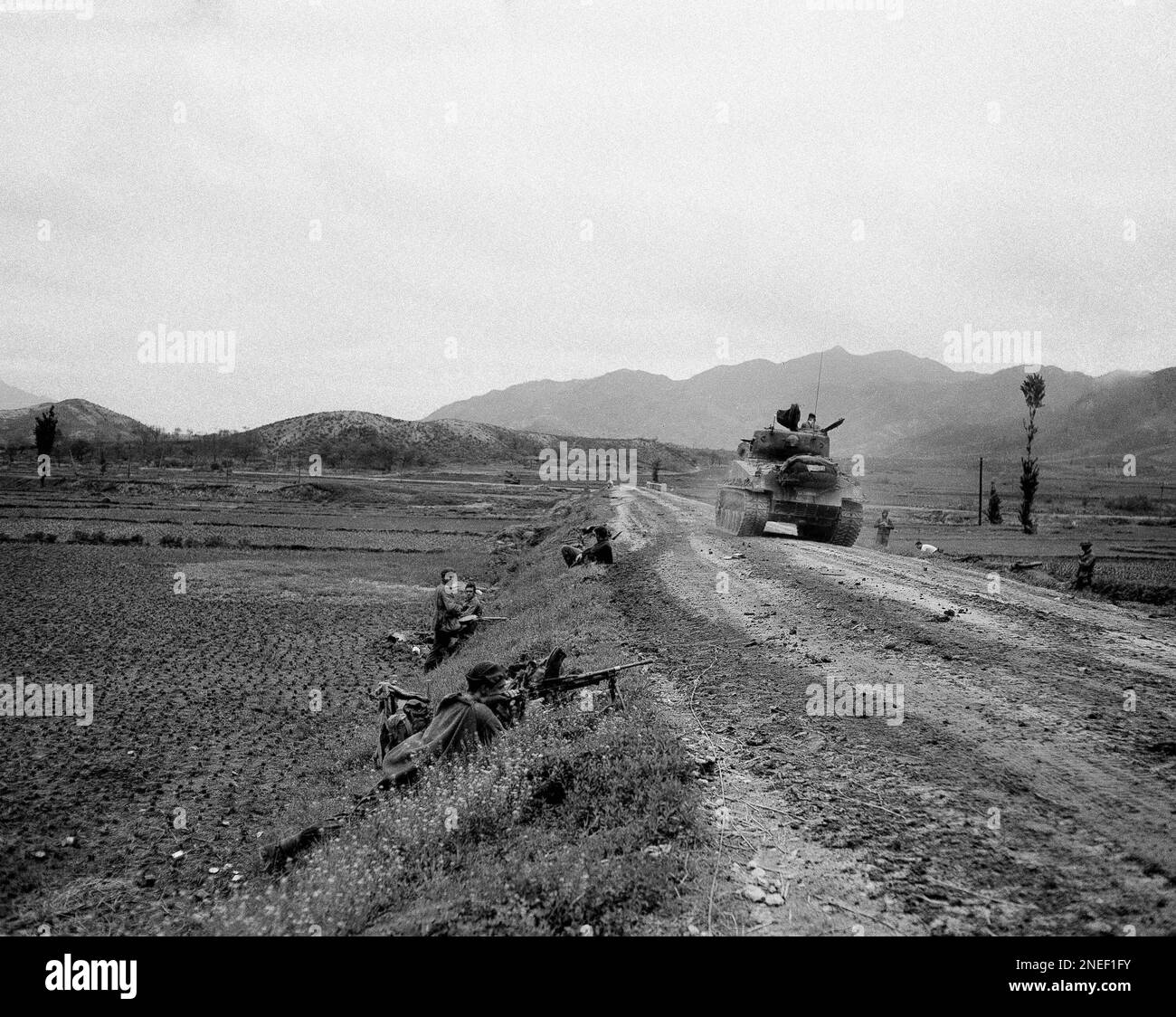 A Canadian machine gunner guards the road north of Uijeongbu as a