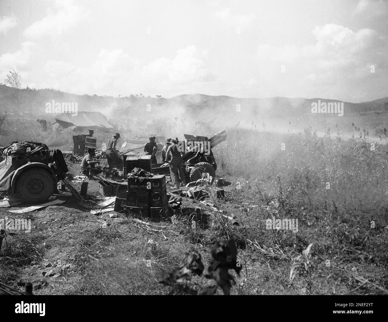 A battery of guns of the 10th New Zealand Field Artillery fires at