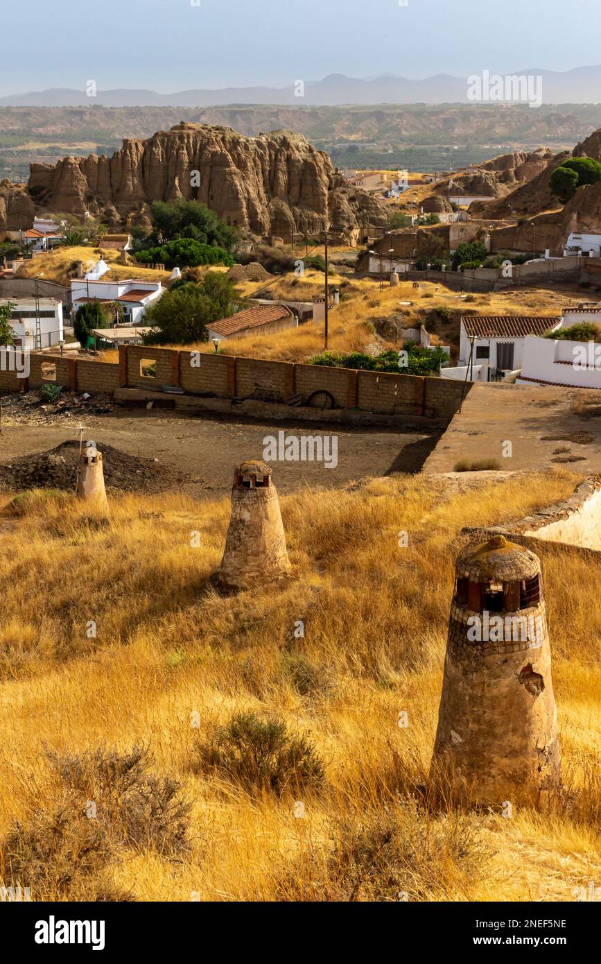 Chimneys of underground cave houses in the Barrio de Cuevas area of Guadix a town in Andalucia in southern Spain. Stock Photo