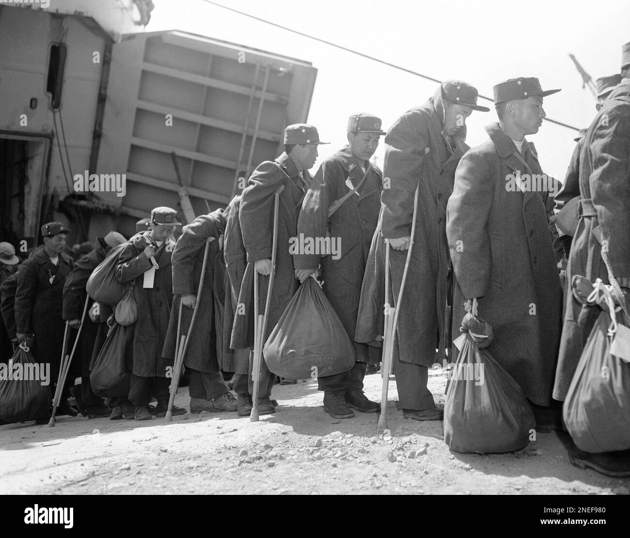 Solemnfaced North Korean disabled prisoners of war disembark from a