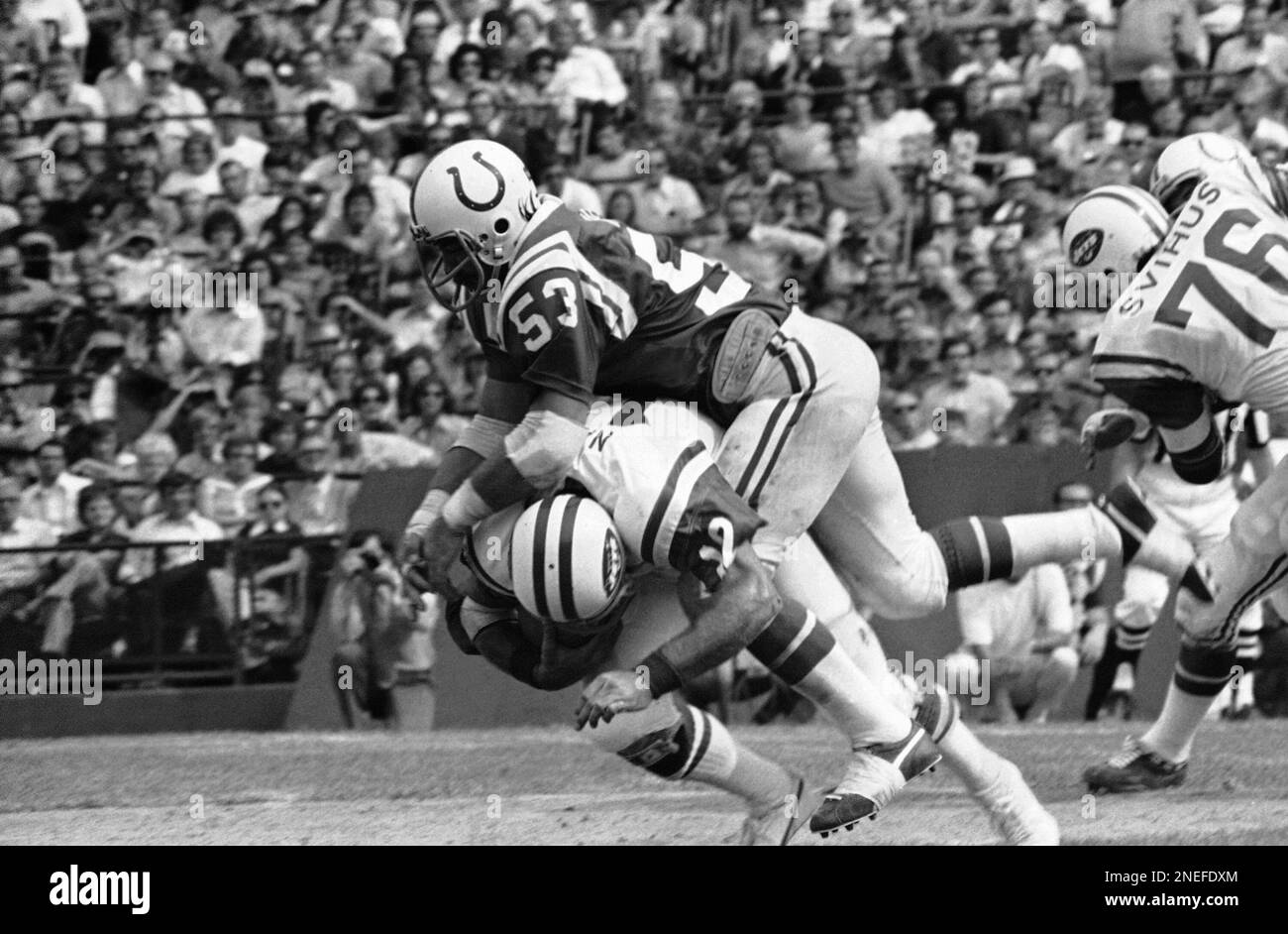 New York Jet quarterback Joe Namath is slammed to the ground by