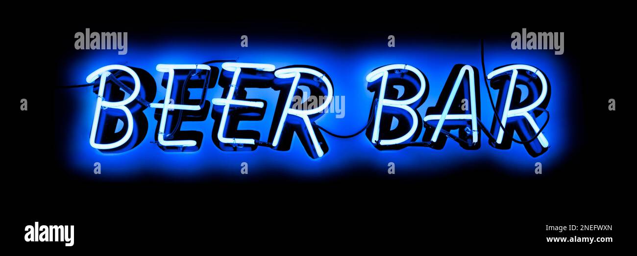 A blue neon light shaped into the phrase: 'Beer bar'. Stock Photo