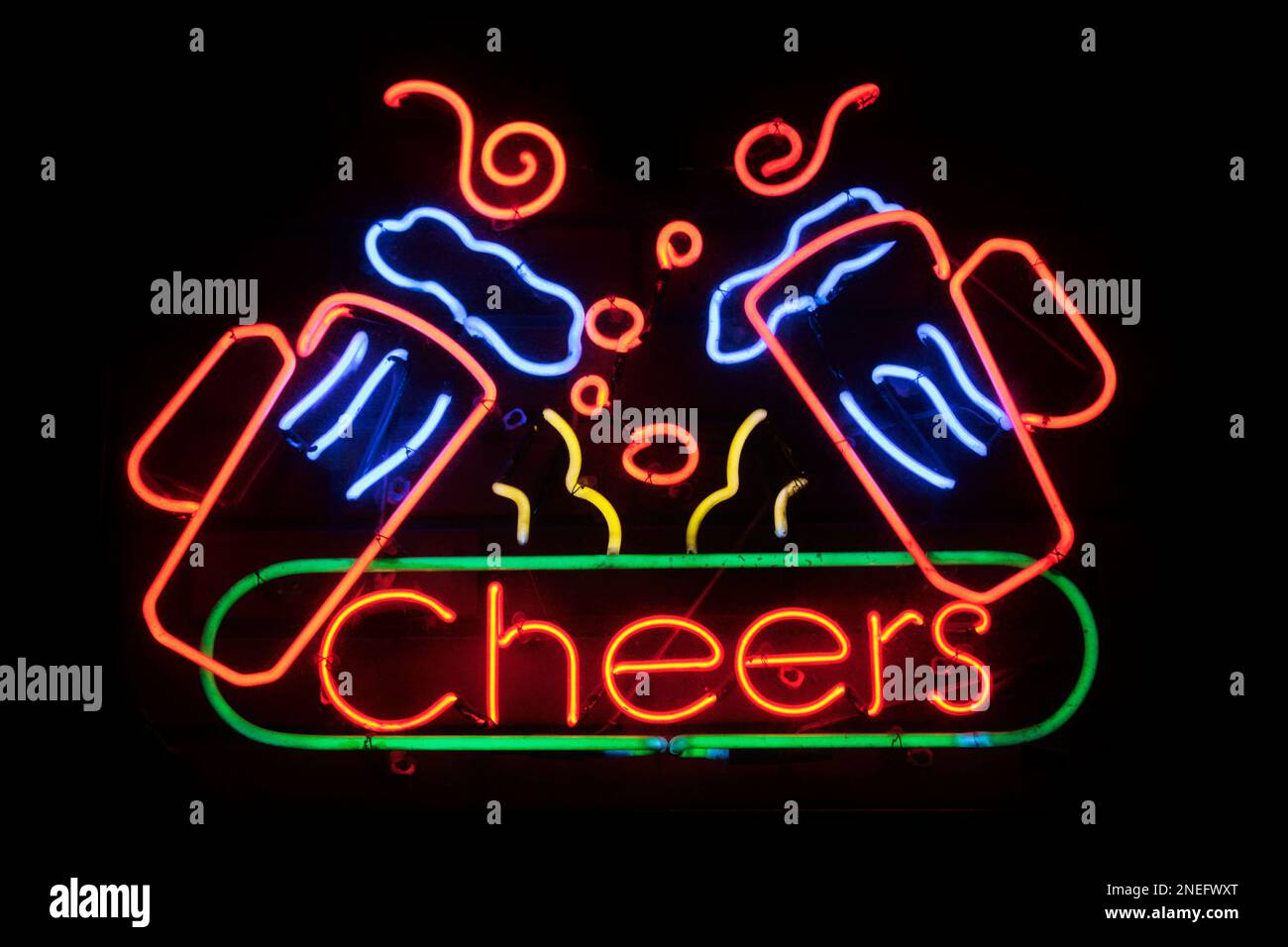 Neon light shaped into the word “Cheers” with two pint of beers above it. Stock Photo