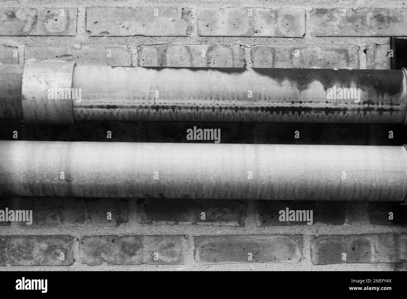 Curated visual reference: Fresh Look at Typical Common Metal Pipes Running Along A Brick Wall In