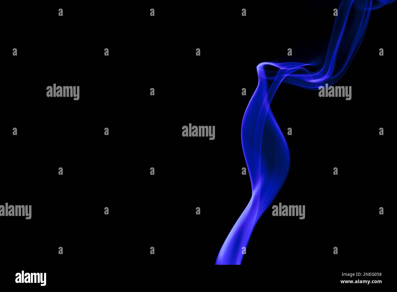 Abstract blue smoke swirling on a black background with a copy space on ...