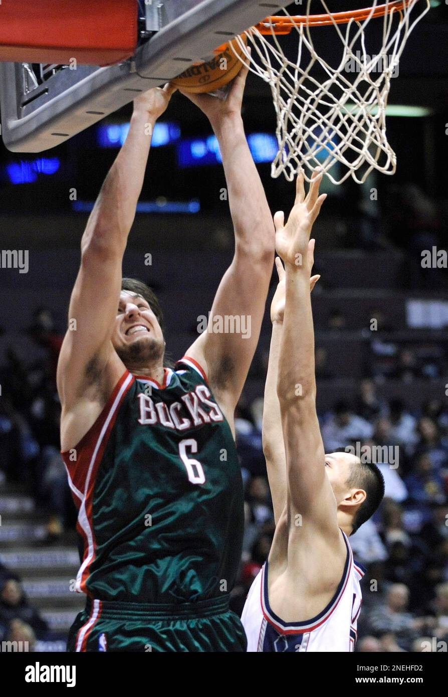 Milwaukee Bucks' Andrew Bogut, left, of Australia, goes up with a shot over New  Jersey Nets' Yi Jianlian, of China, during the fourth quarter of an NBA  basketball game Tuesday, Jan. 5