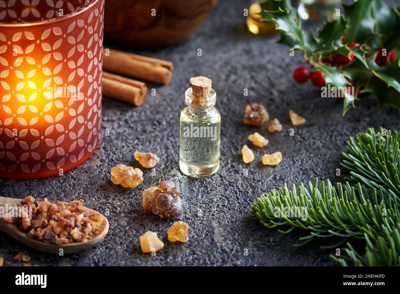 A bottle of essential oil with frankincense, myrrh, fir and holly Stock Photo