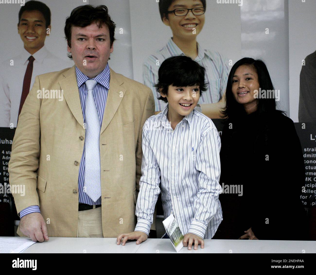Ainan Celeste Cawley, 10, poses with his father Valentine Cawley, left, and his mother Syahidah Osman after a press conference in Kuala Lumpur, Malaysia, Monday, Jan. 4, 2010. The Singaporean child prodigy who passed 10th grade chemistry at the age of 7 is moving to Malaysia for higher education because the island-state is too rigid to accommodate gifted children, his father said Monday. (AP Photo/Lai Seng Sin) Stock Photo