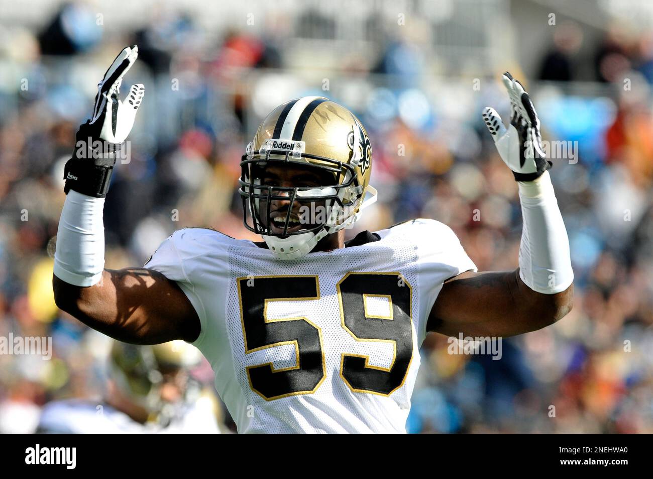 New Orleans Saints linebacker Anthony Waters hols up his jersey