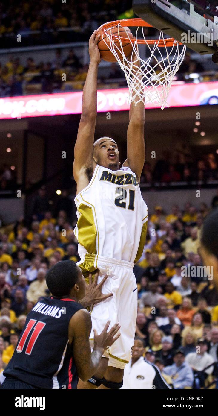 Missouri's Laurence Bowers, top, dunks over Georgia's Vincent Williams ...