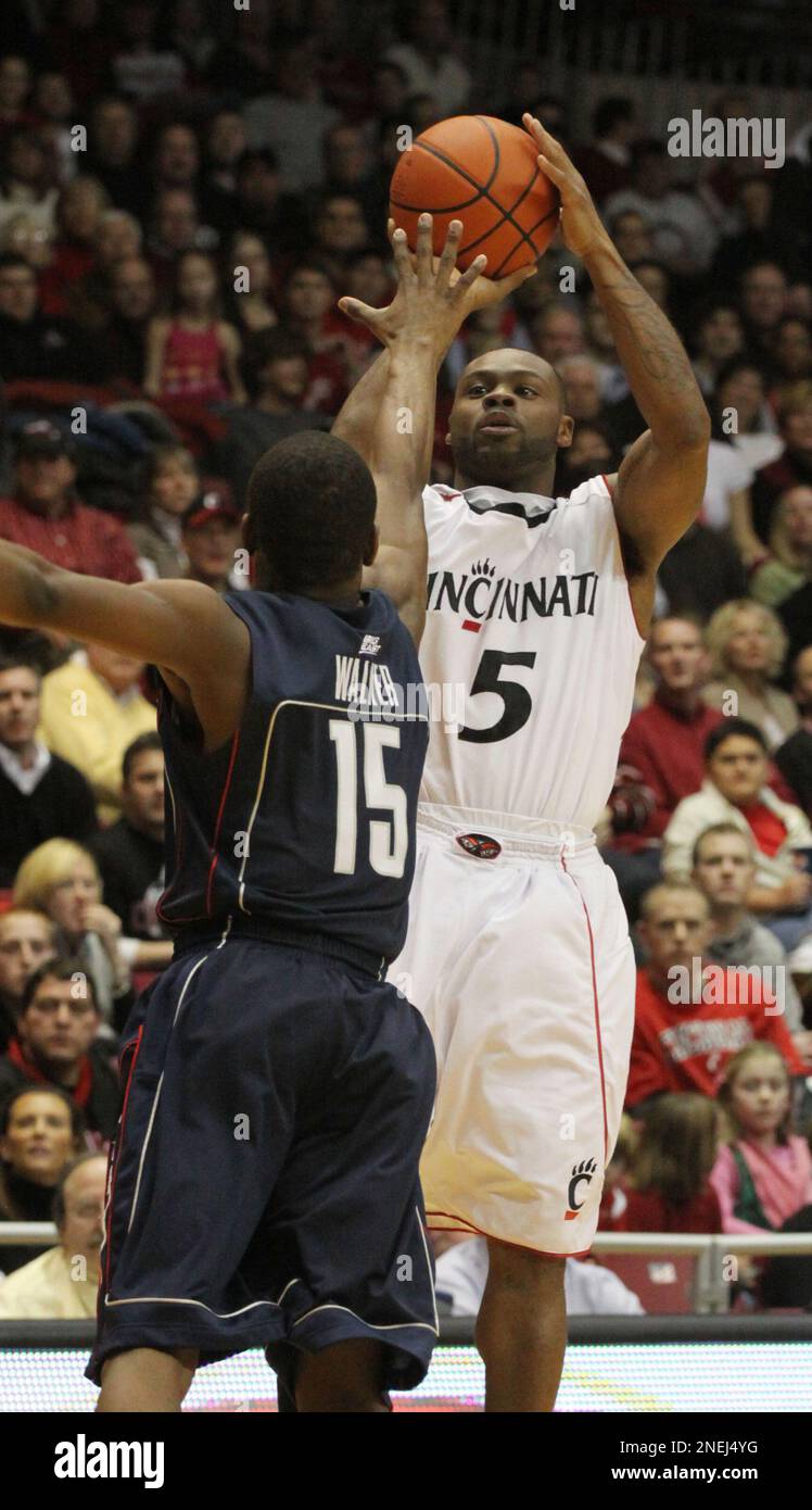Cincinnati's Deonta Vaughn, right, shoots a threepoint basket past